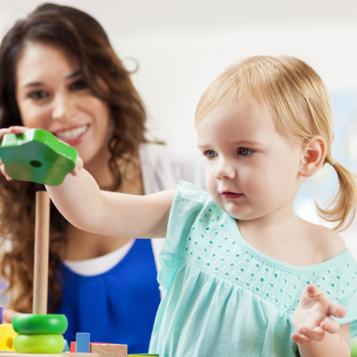 A young girl is playing with a toy in a playroom.