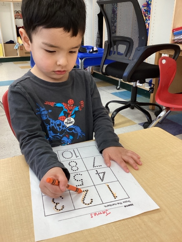 boy writing numbers.