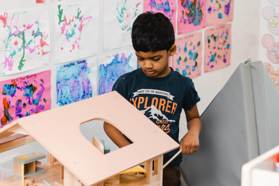 boy playing with model house.